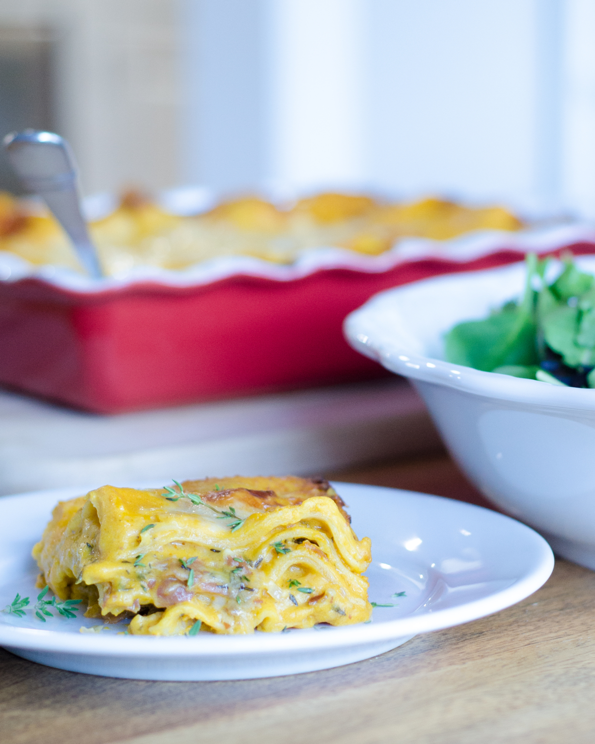 Savory pumpkin lasagna recipe featuring easy canned pumpkin, prosciutto, Gruyere cheese, rosemary, and thyme. Great make ahead recipe for a crowd but easy enough for a weeknight.