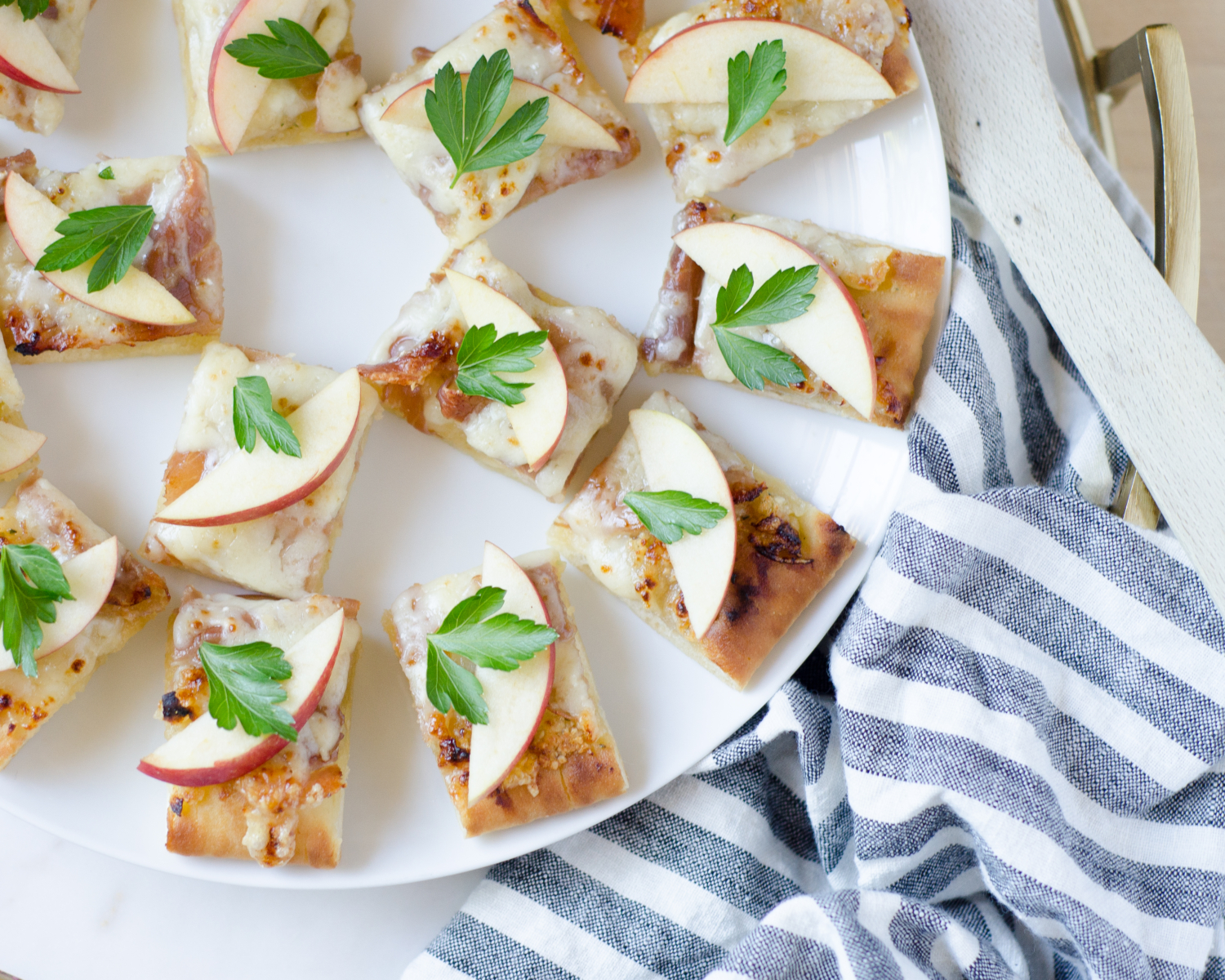 An earthy, flavorful, and easy fall appetizer featuring truffle almond pesto, apples, prosciutto, Gruyere and Havarti cheeses. SO delicious!!!