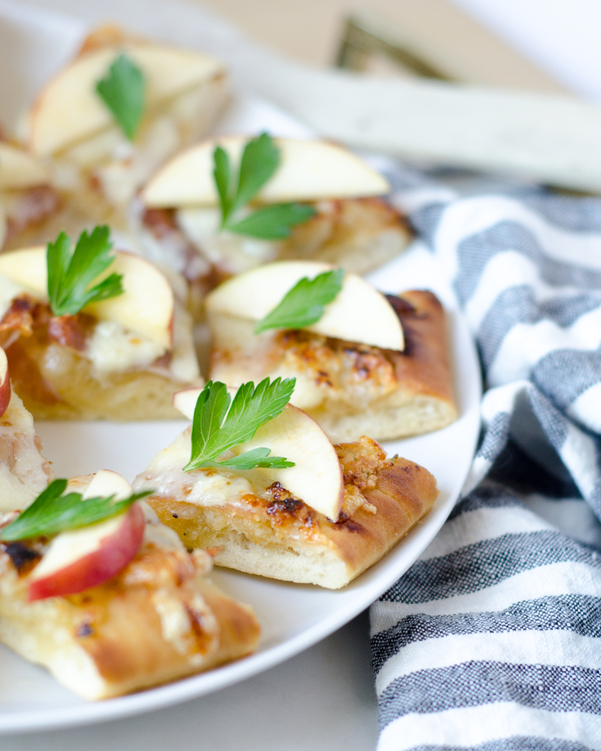 An earthy, flavorful, and easy fall appetizer featuring truffle almond pesto, apples, prosciutto, Gruyere and Havarti cheeses. SO delicious!!!