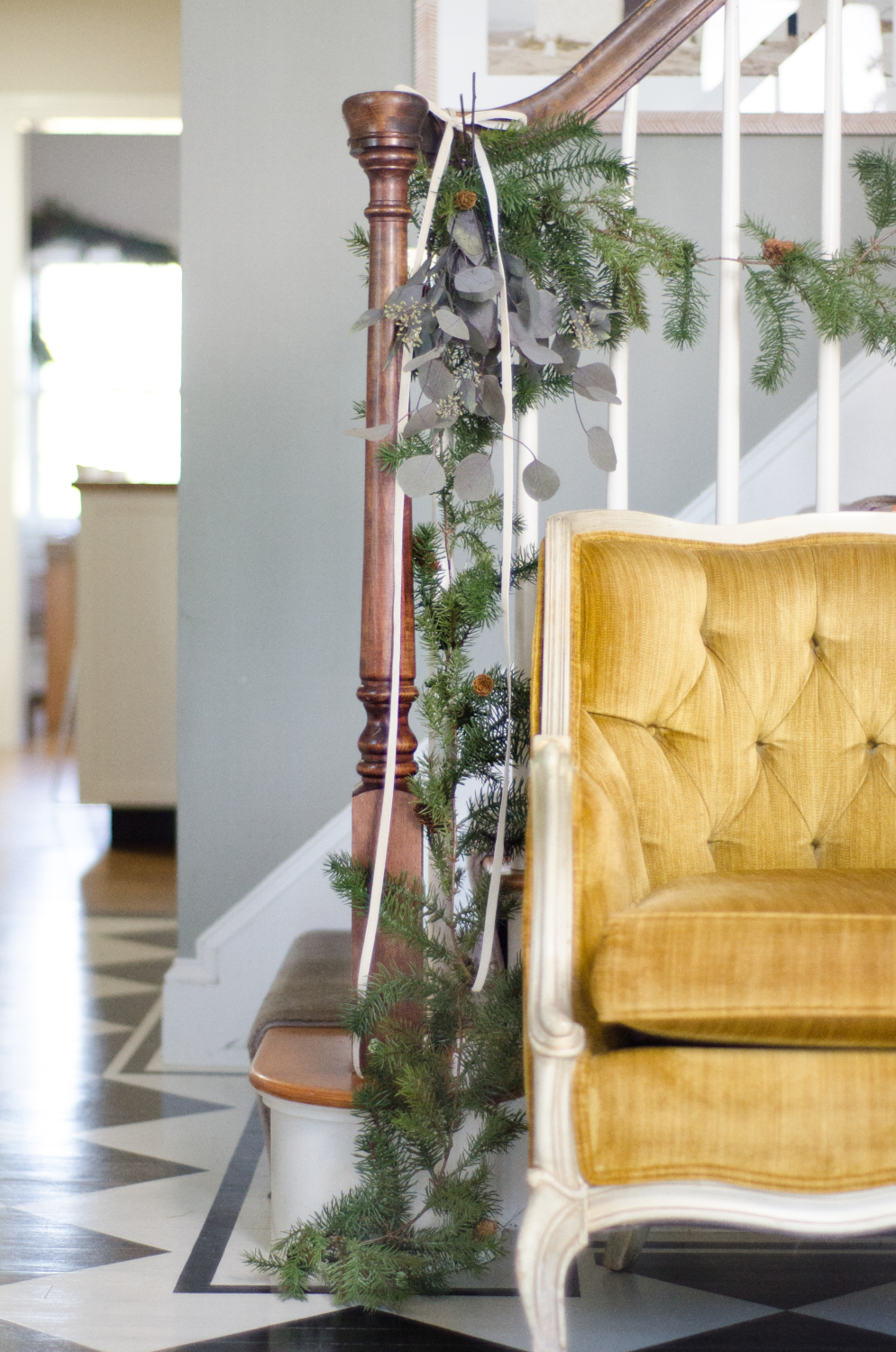 Evergreen and eucalyptus garland with ivory velvet ribbon for Christmas.