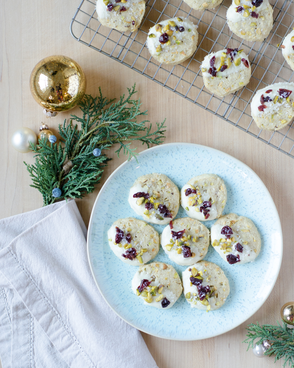 Pistachio cardamom butter cookies that are easy to make and taste nutty, creamy, and delicious. Perfect as a Christmas cookie with festive red and green accents!