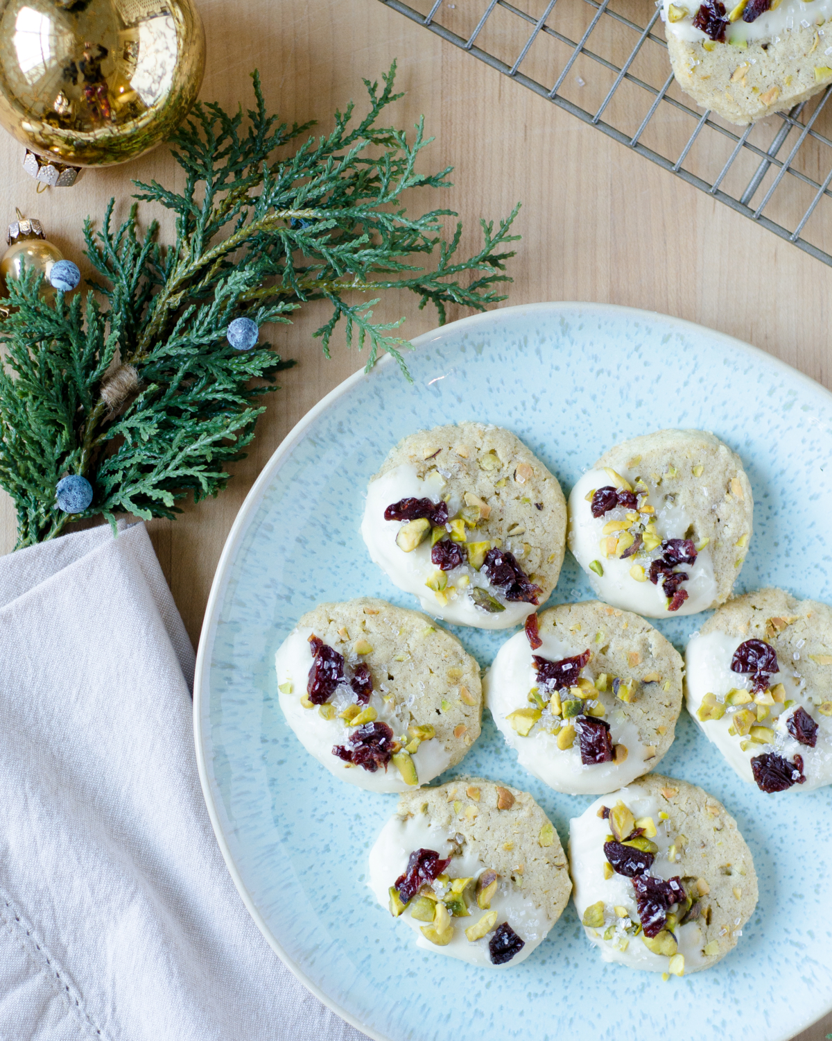 Pistachio cardamom butter cookies that are easy to make and taste nutty, creamy, and delicious. Perfect as a Christmas cookie with subtle red and green!